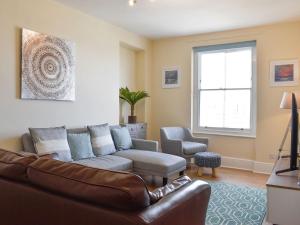 a living room with a couch and a chair at Capstone Reach in Ilfracombe