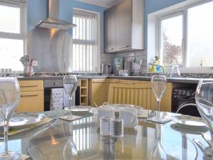 a kitchen with a table with wine glasses on it at Upper Deck in Turnchapel