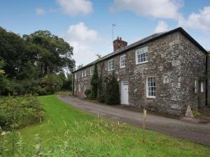 an old stone house on a road at Shore Cottage - Uk12524 in Garlieston