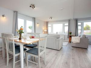 a kitchen and living room with a table and chairs at Lookout Lodge-uk36700 in Newton Abbot