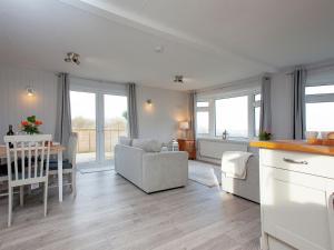 a kitchen and living room with a table and chairs at Lookout Lodge-uk36700 in Newton Abbot