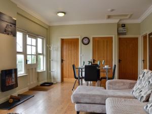 a living room with a couch and a table at Powis Castle View in Forden