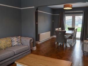 a living room with a couch and a table at Seaholme in Seahouses