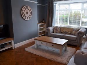 a living room with a couch and a coffee table at Seaholme in Seahouses
