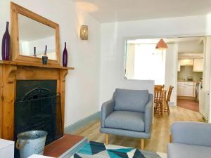 a living room with a chair and a mirror at Summerland Terrace in Kingswear