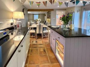 a kitchen with a table and a dining room at Gilbertson Cottage in Wheldrake