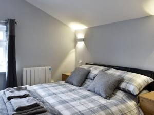 a bedroom with a bed with two pillows at Cuillin View Apartment - Uk12529 in Arisaig