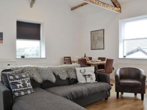 a living room with a couch and a table at Katellen Cottage in Threlkeld