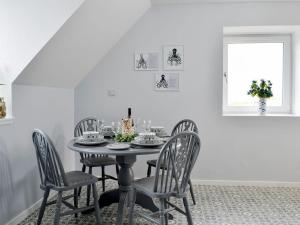 a dining room with a table and chairs at Forvie View in Collieston