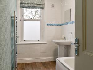 a bathroom with a sink and a window at Beachcomber Corner in Lytham St Annes