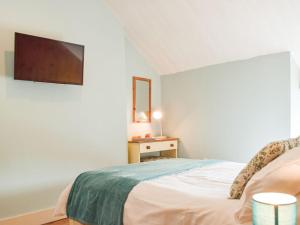 a bedroom with a bed with a tv on the wall at Uk34913 - Bwlchgraig Fach in Nantcwnlle