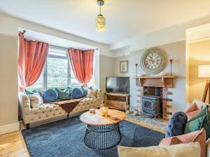 a living room with a couch and a table at Arfryn in Carno