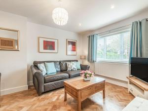 a living room with a couch and a table at Whits End House in Whitstable