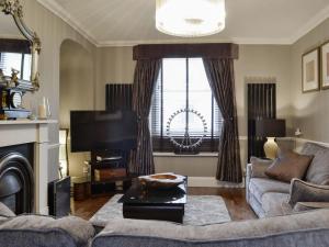 a living room with a couch and a tv at The Apartment in Brecon