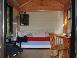 a bed in a room with a chair and a desk at Red Lodge - Uk10988 in Llandogo