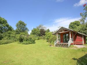 a small red cabin with a large yard at Red Lodge - Uk10988 in Llandogo