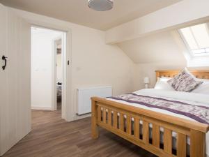 a bedroom with a bed and a skylight at Willow Cottage At Naze Farm-uk32760 in Chinley