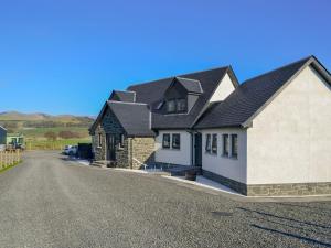 a house on a street with a driveway at Blueacres in Skirling