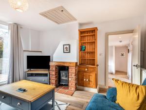 a living room with a fireplace and a tv at River View in Trimingham