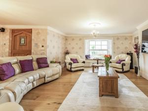 a living room with a couch and chairs and a table at Allerton House in Isham