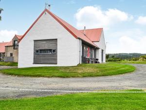 a white house with a red roof at The Stable - Uk33400 in Isle of Gigha
