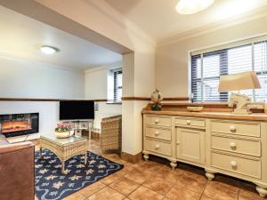 a living room with a dresser and a tv at The Stables - Uk30946 in Barthomley