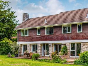 a house with a red roof and a yard at Moorlands in Chilcompton