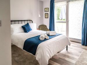 a bedroom with a bed with towels on it at Moorlands in Chilcompton