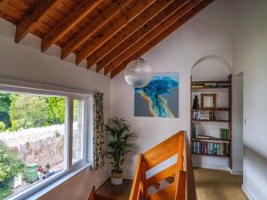 a room with a staircase with a window and a book shelf at Moorlands in Chilcompton