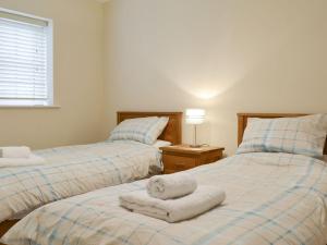 two beds with towels on them in a bedroom at Croft Cottage 2 - Uk10588 in Stillington