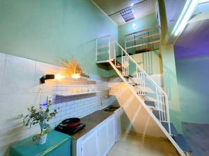 a spiral staircase in a room with green walls at Cúc cu Homestay 3 in Kiến An