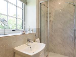 a bathroom with a sink and a shower at The Barn - Uk2475 in West Witton