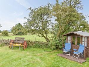 a gazebo and two chairs and a bench in a yard at Skipton Shepherds Hut - Dales View in Cononley