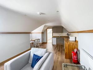 a living room with a couch and a kitchen at The Oaks - Uk33998 in Child Okeford