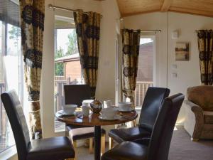 a dining room with a table and chairs at Lodge D- Uk33090 in Dinnet