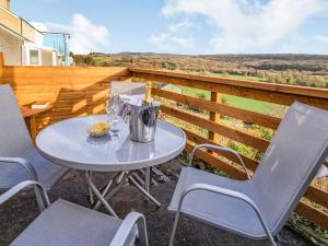 a table and chairs on the balcony of a house at Number 4 in Llandeilo