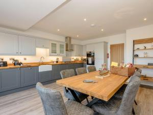 a kitchen and dining room with a wooden table and chairs at Marina House 