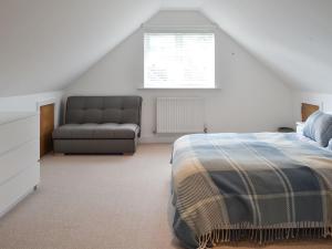 a bedroom with a bed and a couch at Quay House in Burton