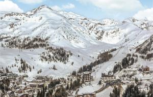 a snow covered mountain with a town and a ski slope at Gorgeous Apartment In Vason With House A Mountain View in Vason