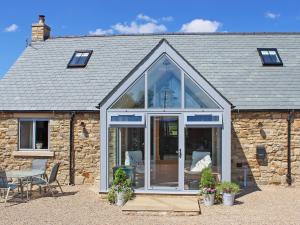 an extension to a stone cottage with a conservatory at Pasture View in Barnard Castle