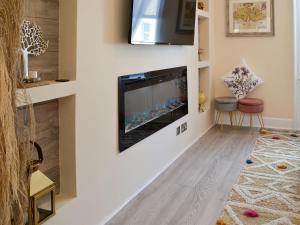 a living room with a flat screen tv on a wall at Cairnsmore - Uk34533 in Newton Stewart