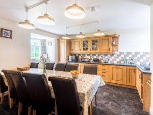 a kitchen with a table and some chairs and a counter at Well Farmhouse - Uk11880 in North Tamerton