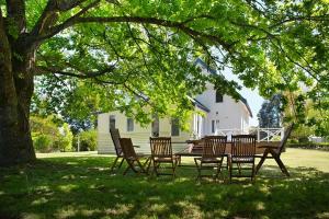 a table and chairs under a tree in a yard at The Church at Lyonville - Daylesford Region in Lyonville