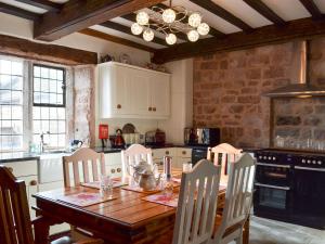 a kitchen with a wooden table with chairs around it at Dairy House Farm in Horton