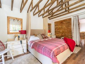 a bedroom with a bed and a brick wall at The Little House In Hull in Hull