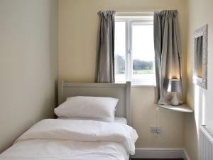 a bedroom with two beds in front of a window at Five Dorchester Drive - Uk32043 in Inglewhite