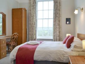 a bedroom with a large bed and a window at Apartment 3-uk33247 in Grayrigg