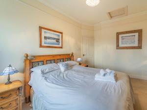 a bedroom with a large bed with towels on it at Mell Fell in Watermillock