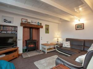 a living room with a couch and a fireplace at Greenbank Farm in Saint Dennis