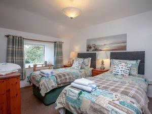 a bedroom with two beds and a window at Greenbank Farm in Saint Dennis